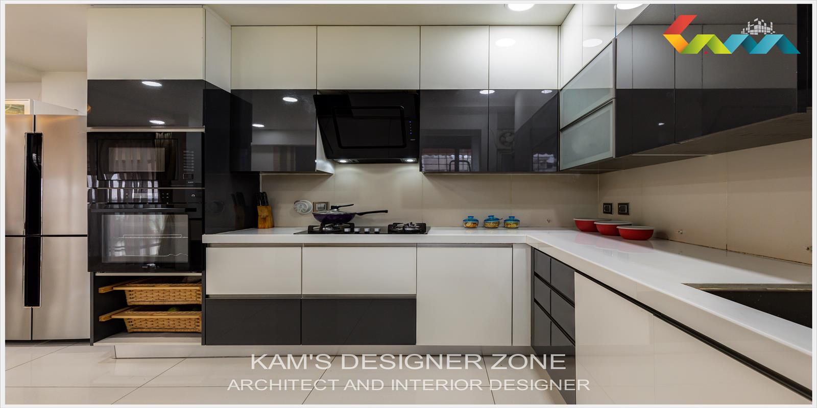 A L-Shape Modular Kitchen With Black and White Cabinets.
                  